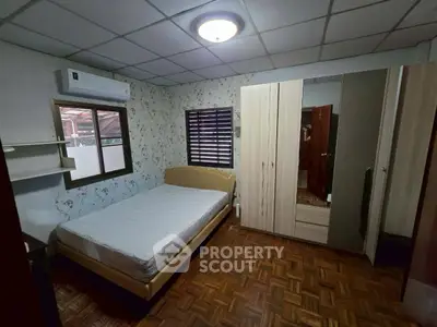 Cozy bedroom with parquet flooring and modern wardrobe
