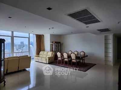 Spacious living room with city view and elegant dining area