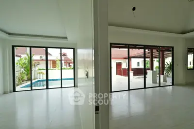 Spacious modern home with large sliding glass doors and pool view