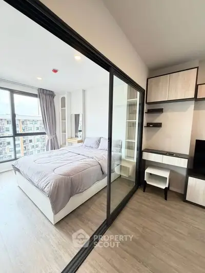 Modern bedroom with large windows and stylish decor in a high-rise apartment.
