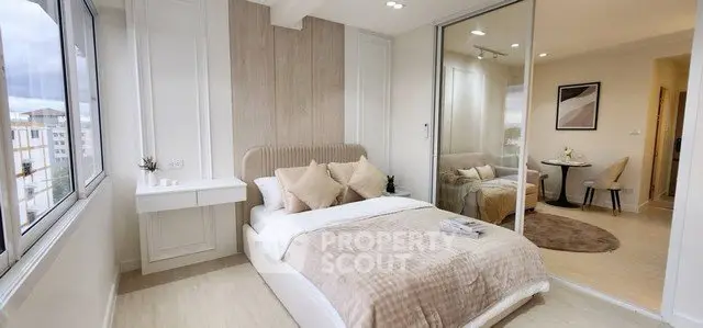 Modern bedroom with large windows and stylish decor in a luxury apartment.