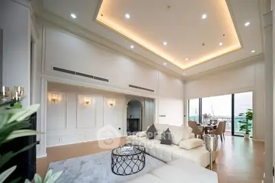 Luxurious living room with high ceilings and elegant decor, featuring a spacious open layout and stunning views.