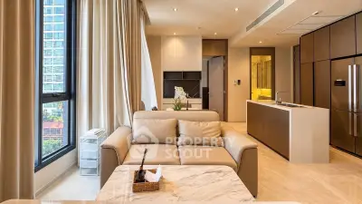 Luxurious modern living room with open kitchen and stunning city view, featuring elegant furnishings and natural light.