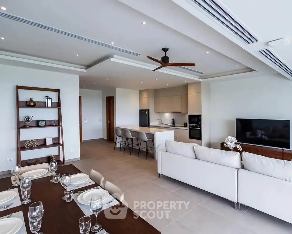 Spacious open-plan living room with modern kitchen and elegant dining area