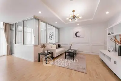 Elegant living room with modern decor and stylish lighting in a spacious apartment.