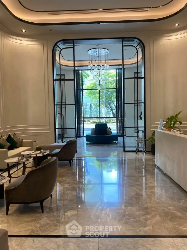 Luxurious lobby with elegant seating and chandelier, offering a sophisticated ambiance and stunning garden view.