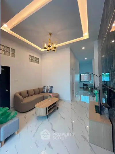 Modern living room with elegant lighting and stylish furniture, featuring a sleek marble floor and contemporary decor.