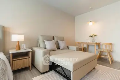 Cozy living room with modern beige sofa and stylish dining area