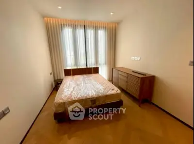 Spacious bedroom with natural light and modern furnishings, perfect for comfortable living.