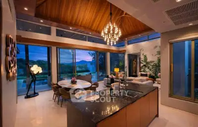 Luxurious open-plan living room with stunning mountain views and elegant decor.