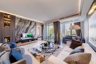 Luxurious modern living room with elegant decor and large windows offering a stunning city view.
