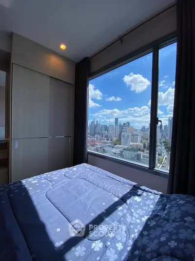 Stunning bedroom with panoramic city view from large window, featuring cozy bedding and ample natural light.