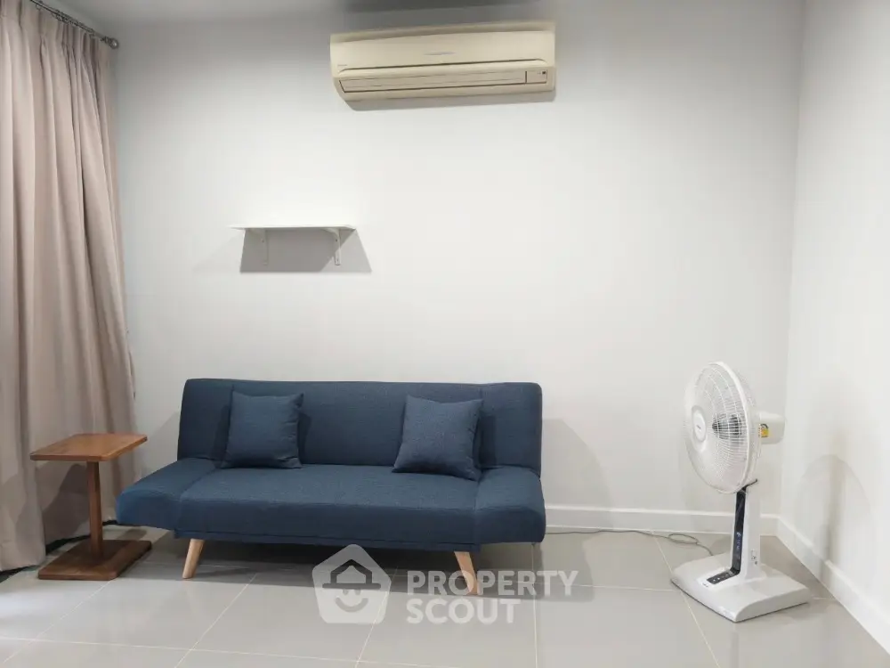 Modern living room with sleek sofa and air conditioning