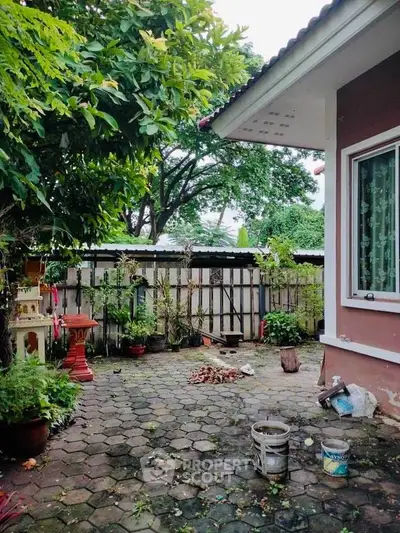 Charming garden patio with lush greenery and cozy outdoor space