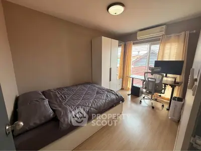 Cozy bedroom with modern furniture and natural light, perfect for a comfortable living space.