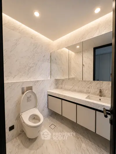Luxurious modern bathroom with marble walls and sleek fixtures, perfect for elegant living.