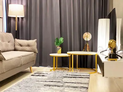 Stylish living room with modern decor, featuring a cozy sofa, elegant tables, and ambient lighting.