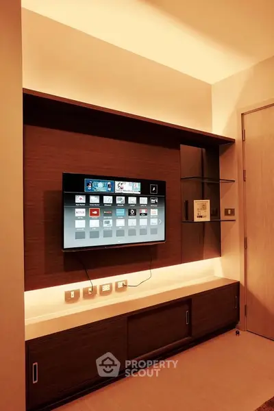 Modern living room with sleek entertainment center and mounted TV, showcasing elegant interior design.