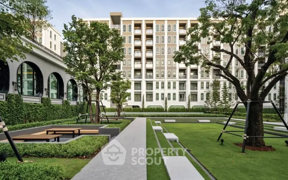 Luxurious apartment building with lush garden and modern architecture