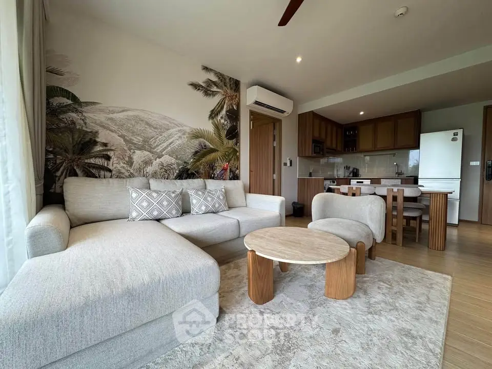 Spacious living room with modern decor and open kitchen layout in a stylish apartment.