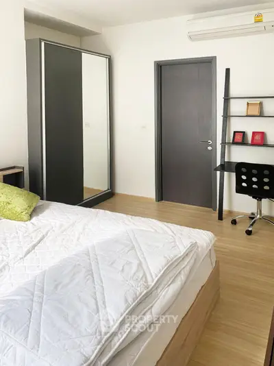 Modern bedroom with sleek furniture and air conditioning, ideal for comfort and style.