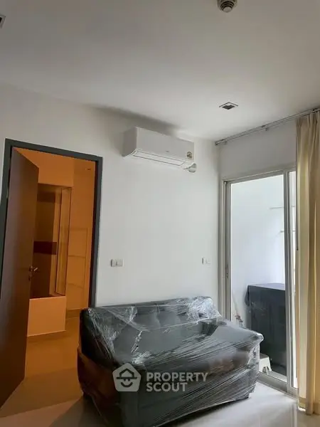 Modern apartment living room with air conditioning and wrapped furniture
