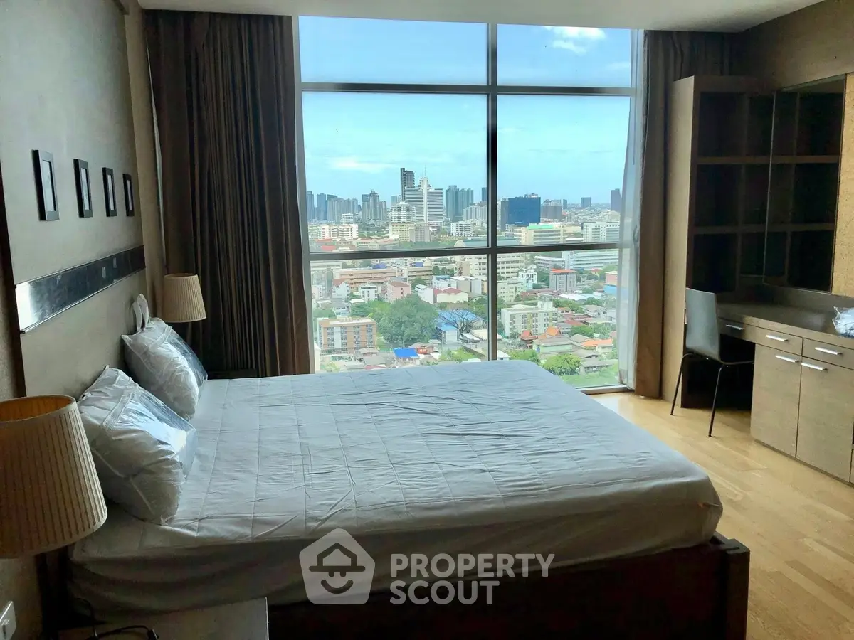 Spacious bedroom with stunning city view and modern furnishings