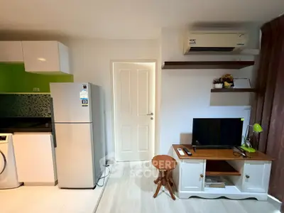 Modern apartment interior with sleek kitchen and cozy living area featuring TV and air conditioning.