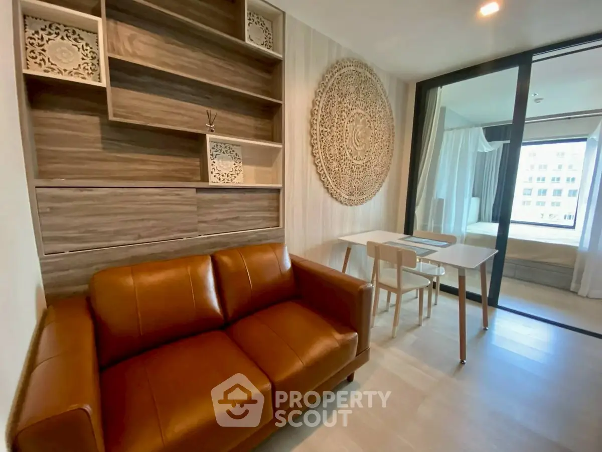 Stylish living room with leather sofa and decorative wall art in modern apartment