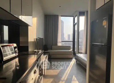 Modern apartment kitchen with sleek appliances and city view from large windows.