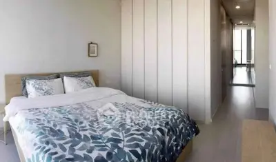 Spacious modern bedroom with stylish decor and ample natural light