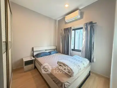 Cozy bedroom with air conditioning and natural light, perfect for restful nights.