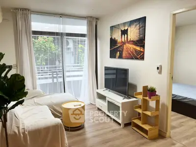Modern living room with balcony view, stylish decor, and natural light.