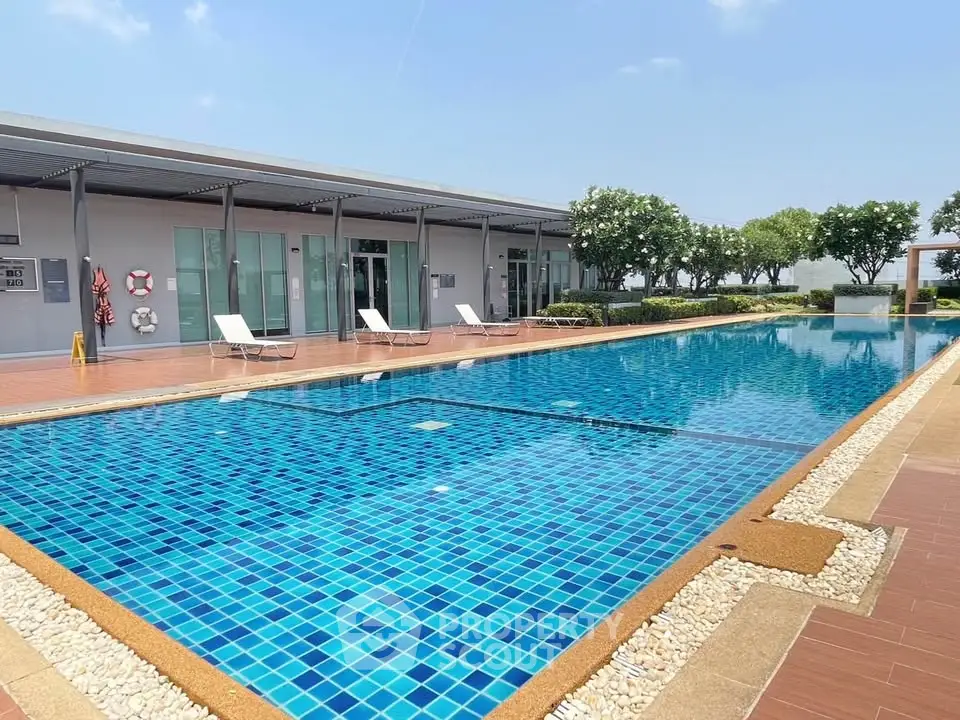 Luxurious outdoor swimming pool with sun loungers and modern design, perfect for relaxation and leisure.