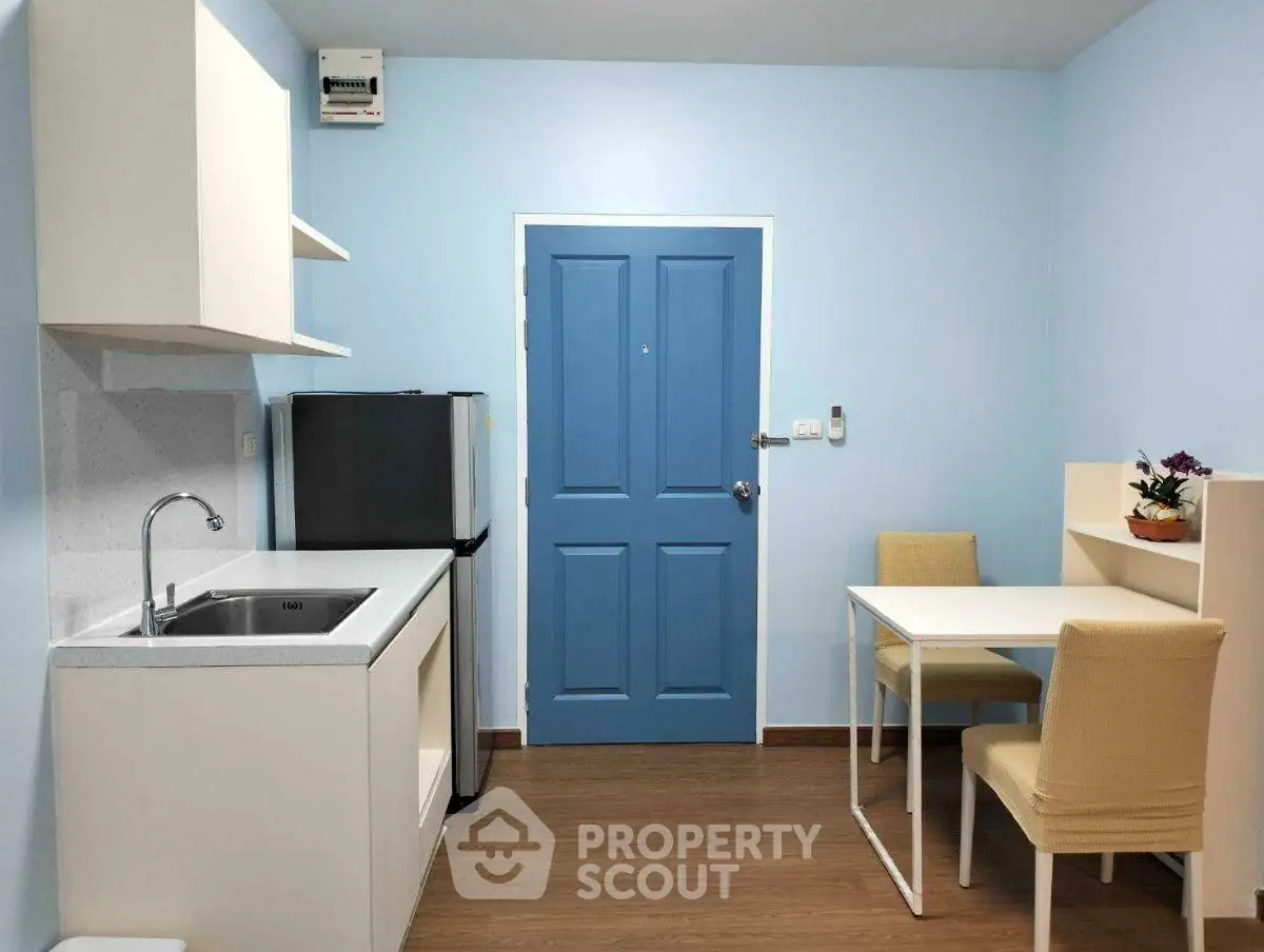 Cozy kitchen with dining area, featuring modern appliances and stylish decor.