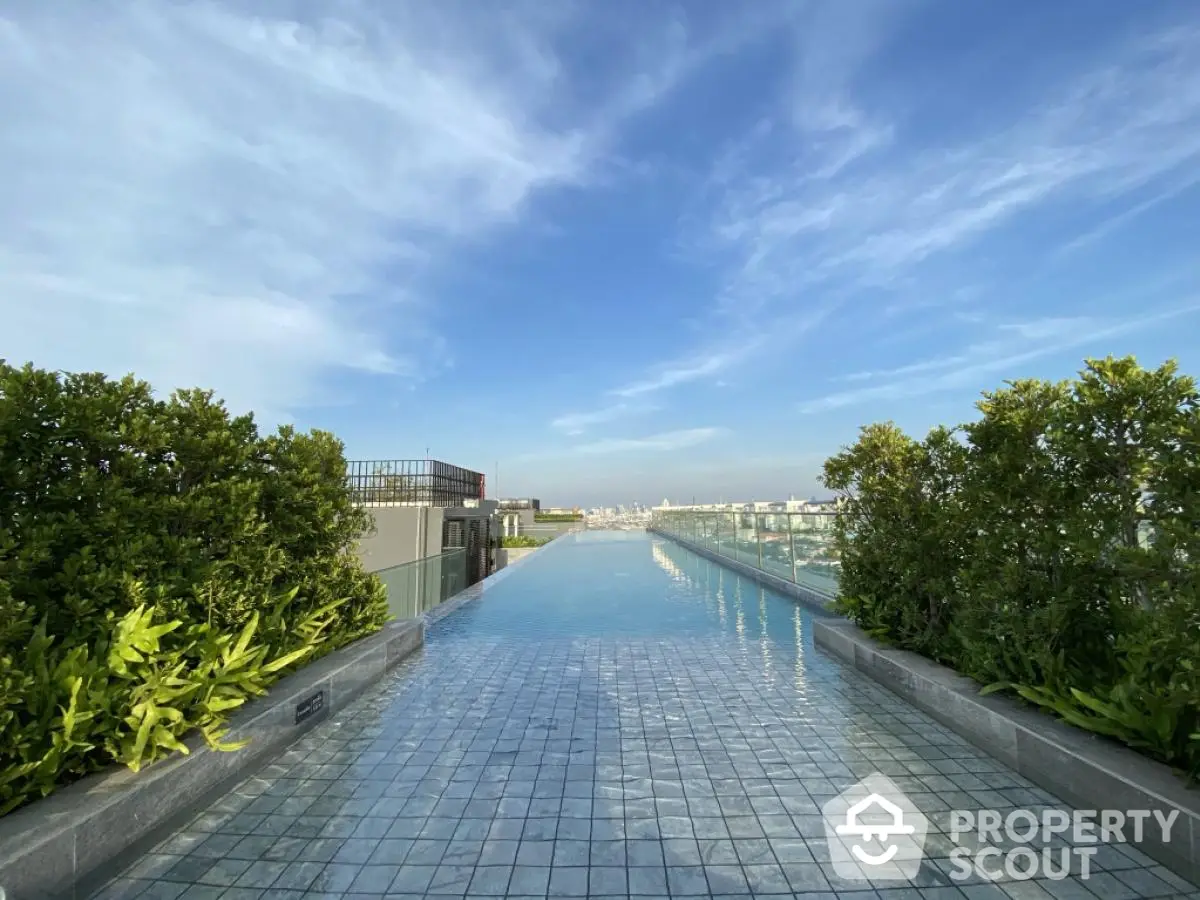 Stunning rooftop infinity pool with panoramic city views and lush greenery