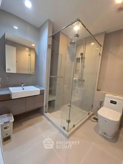 Modern bathroom with glass shower and sleek fixtures