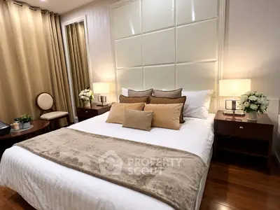 Luxurious bedroom with elegant decor and plush bedding in a modern apartment.