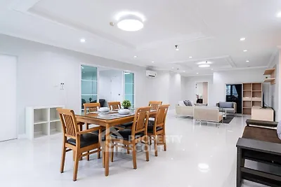 Spacious modern living and dining area with elegant furnishings and bright lighting.