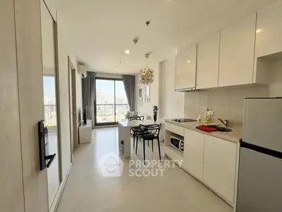 Modern kitchen with open layout and city view in high-rise apartment