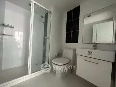 Modern bathroom with glass shower and sleek fixtures