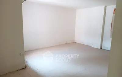 Spacious empty room with tiled flooring and white walls, ideal for customization.