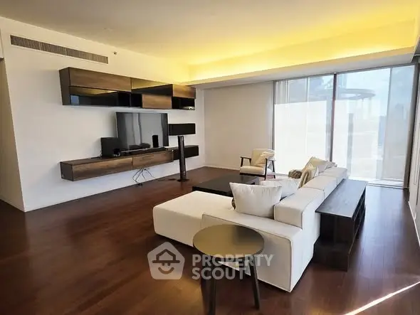 Spacious modern living room with sleek furniture and wooden flooring