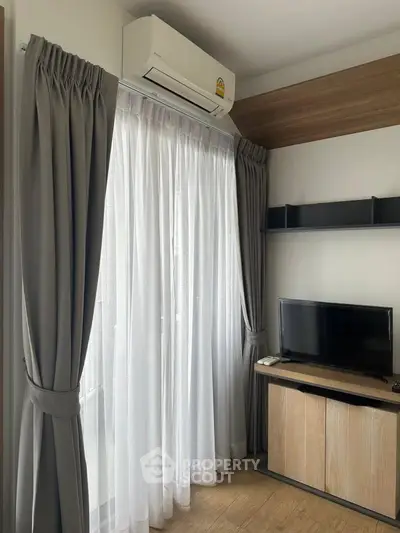 Modern living room with air conditioning and sleek TV setup