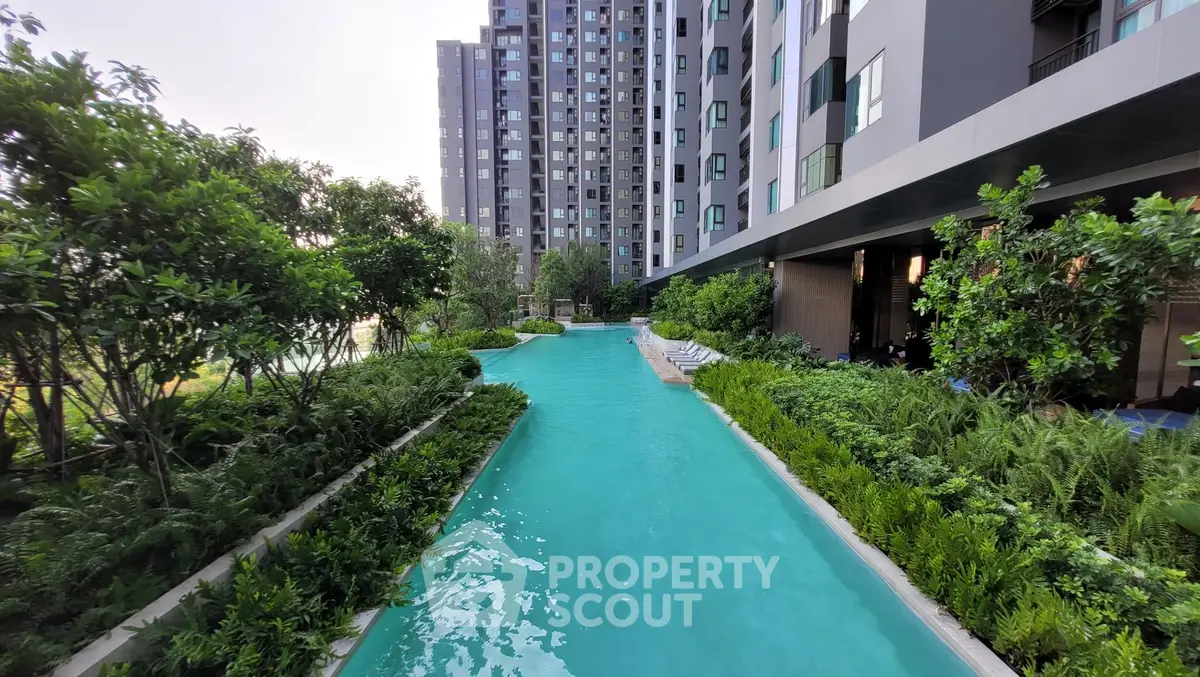 Luxurious condominium with stunning pool and lush greenery, perfect for modern living.