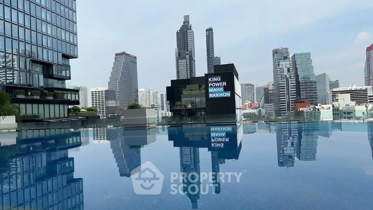 Stunning rooftop pool with city skyline view in luxury high-rise building.