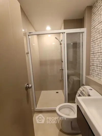 Modern bathroom with glass shower and sleek fixtures