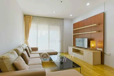 Modern living room with cozy sectional sofa and sleek entertainment unit