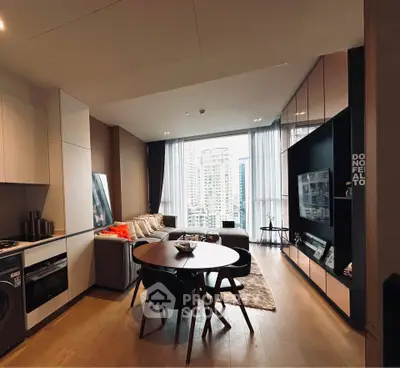 Modern open-plan living room with city view, featuring stylish furniture and sleek kitchen design.