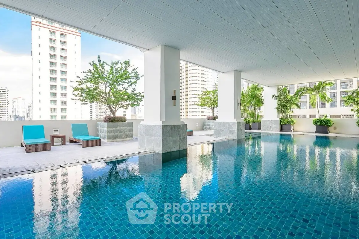 Luxurious rooftop pool with city views and modern design in high-rise building.